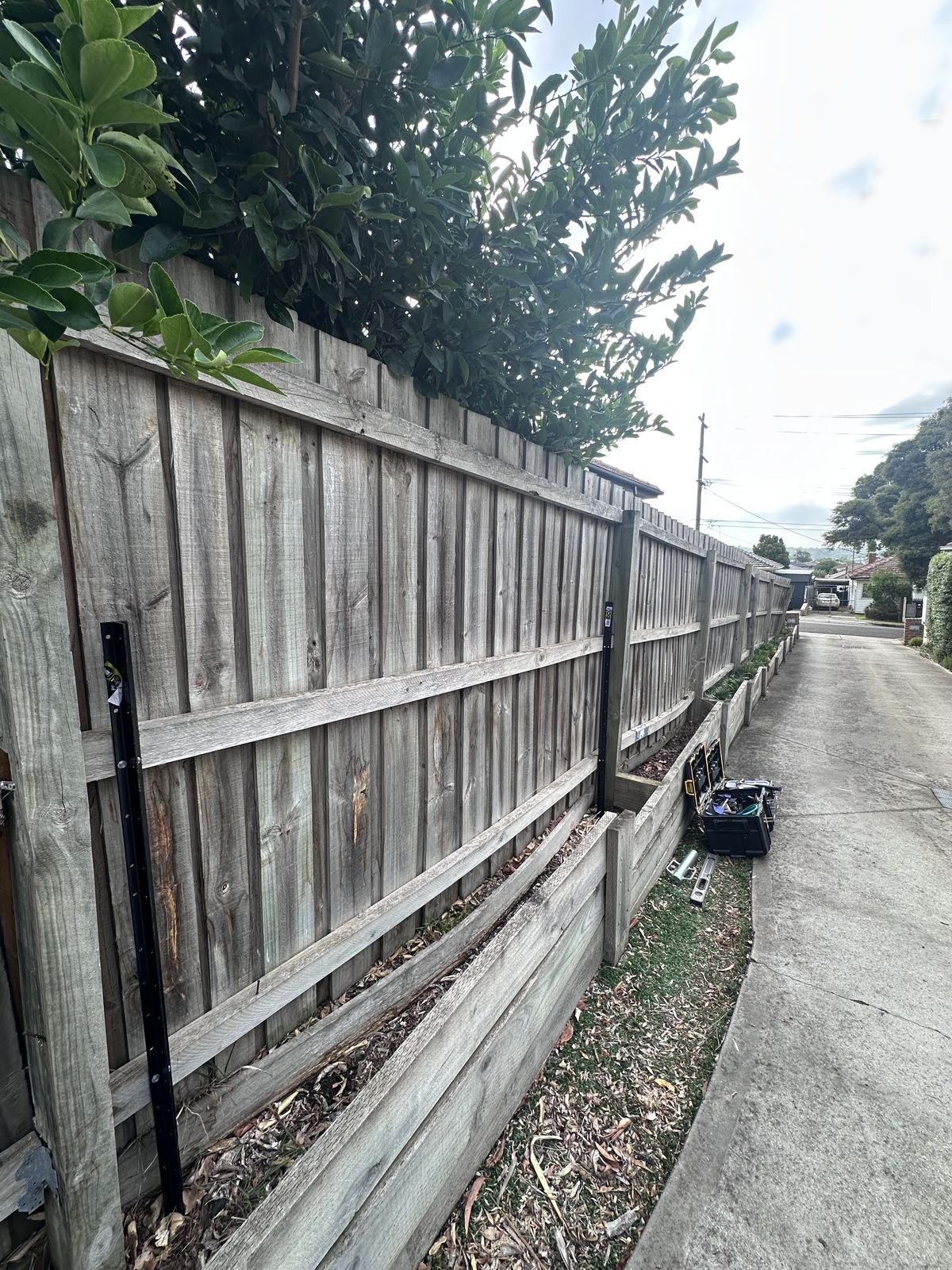 Secured and repaired wooden boundary fence after Northside LPC service
